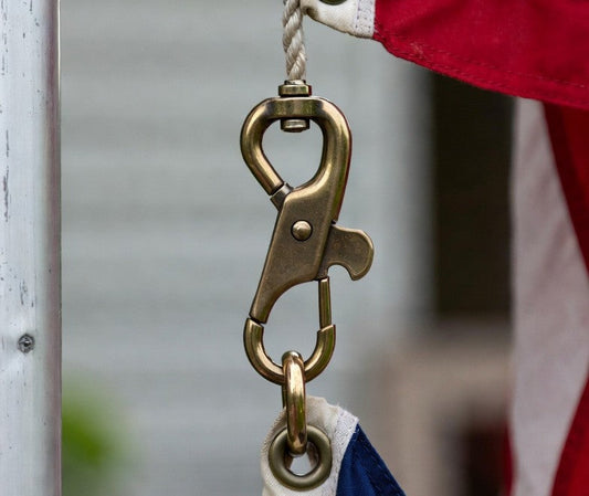 USA flagpole snap hook attached to flag grommet on halyard rope