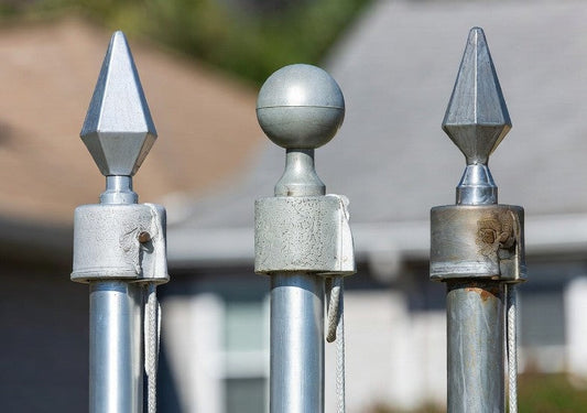 american flagpole materials comparison showing aluminum fiberglass and steell